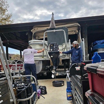 All-Sport team working on boat engine at the dock