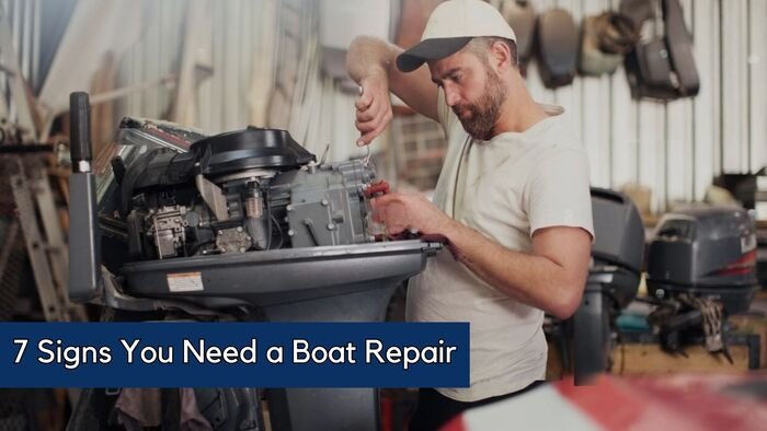 Man repairing outboard engine, signs you need a boat repair